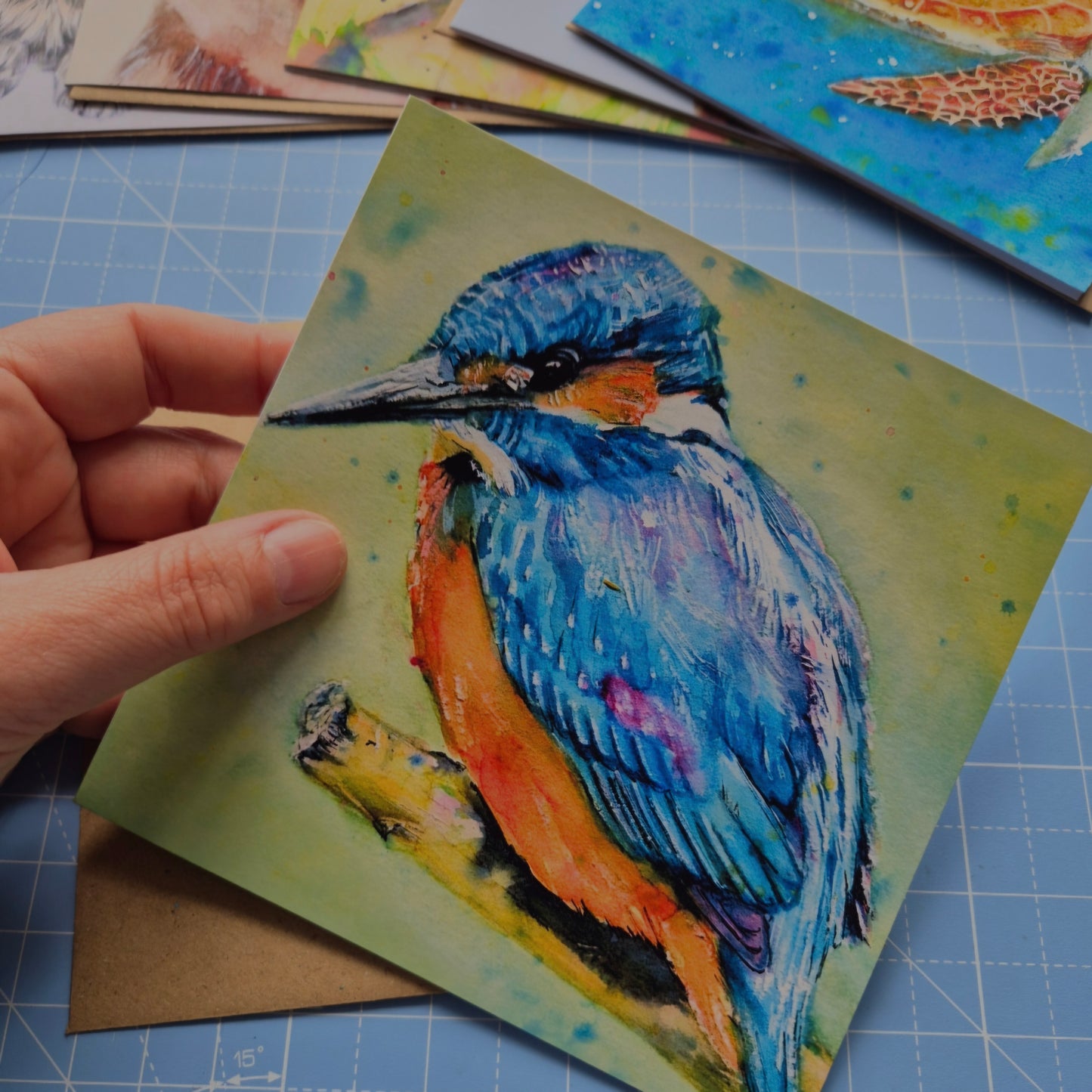 Kingfisher greeting card by Jagos Art held in hand