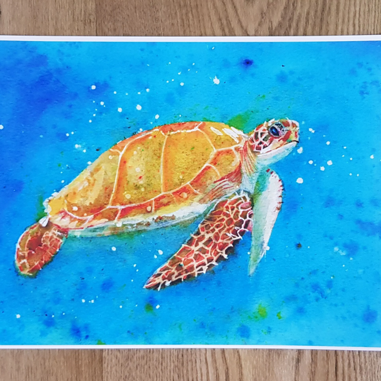 "A A4 art print featuring an original watercolour painting by artist Jagos Art. The artwork showcases a graceful sea turtle swimming through vibrant turquoise waters. Printed on archival paper for lasting vibrancy."