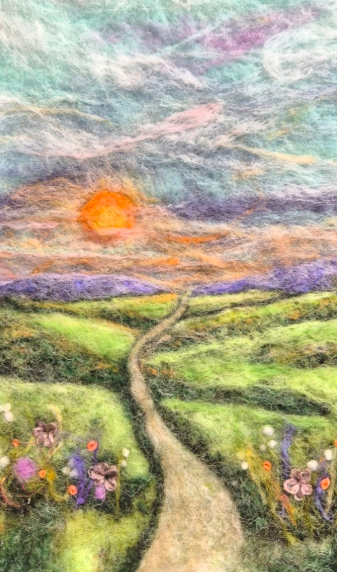 “Country Roads needle-felted wool landscape taking shape, with a winding path, wildflowers and sunset”