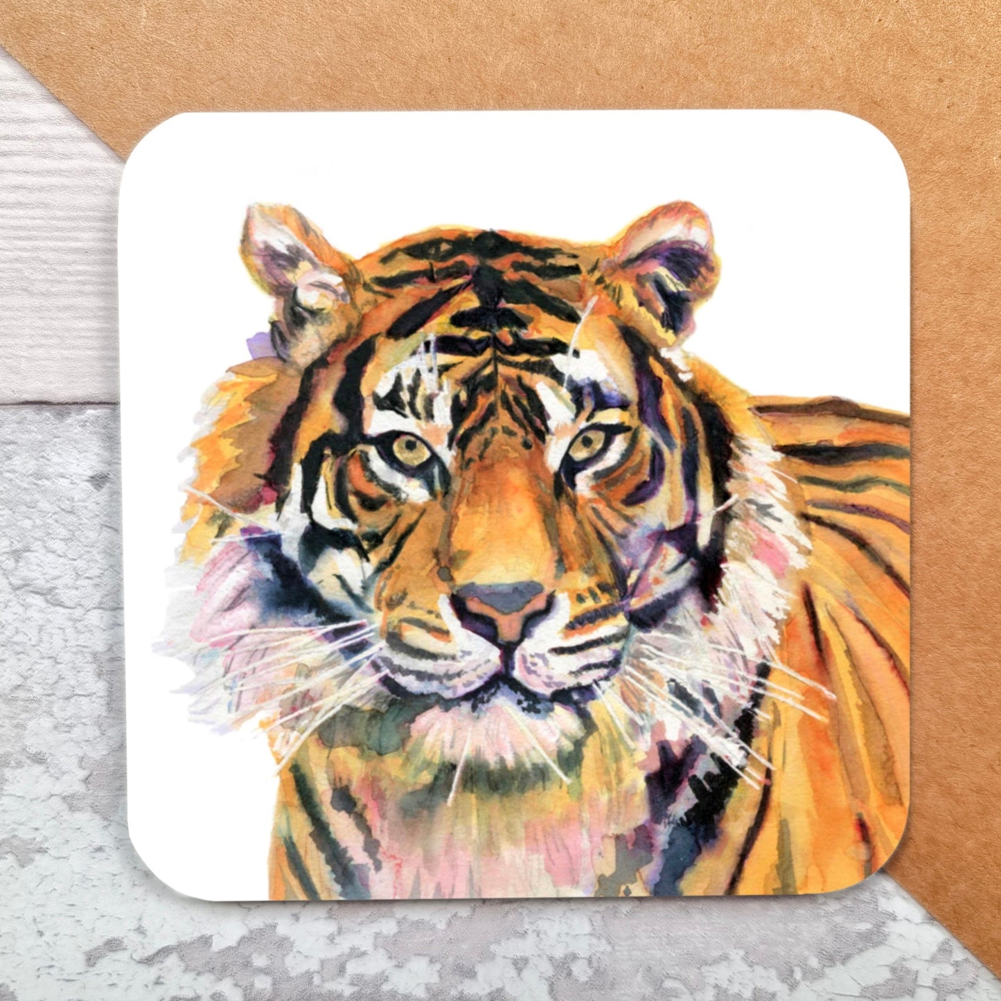 "A square glossy coaster featuring a print of an original watercolour painting by artist Jagos Art. The artwork depicts a majestic tiger in rich orange and purple tones, standing with only its head and shoulders visible from a side angle, gazing intently at the viewer. Printed using the sublimation process."