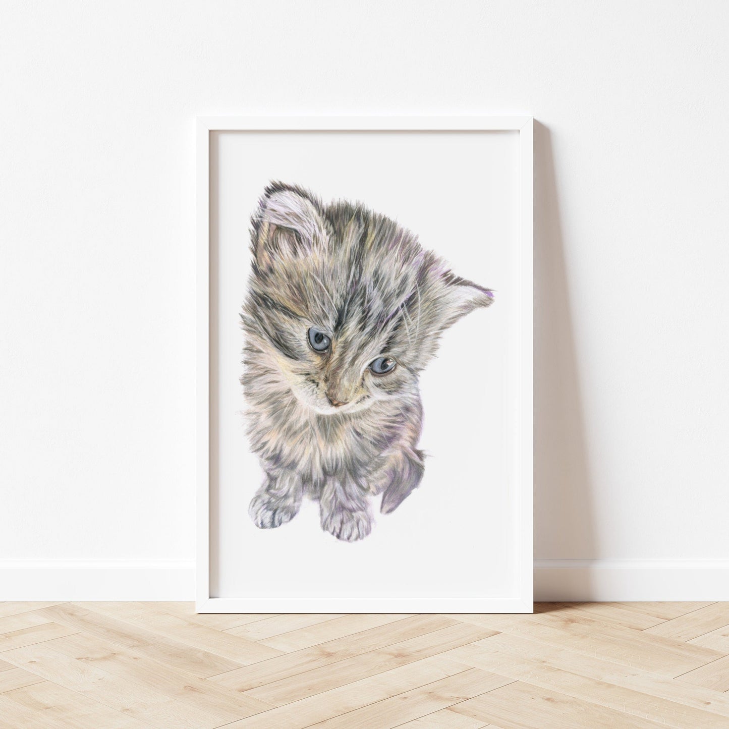 An art print of an original coloured pencil drawing of a gorgeous kitten looking down at the floor with the primary colours being grey