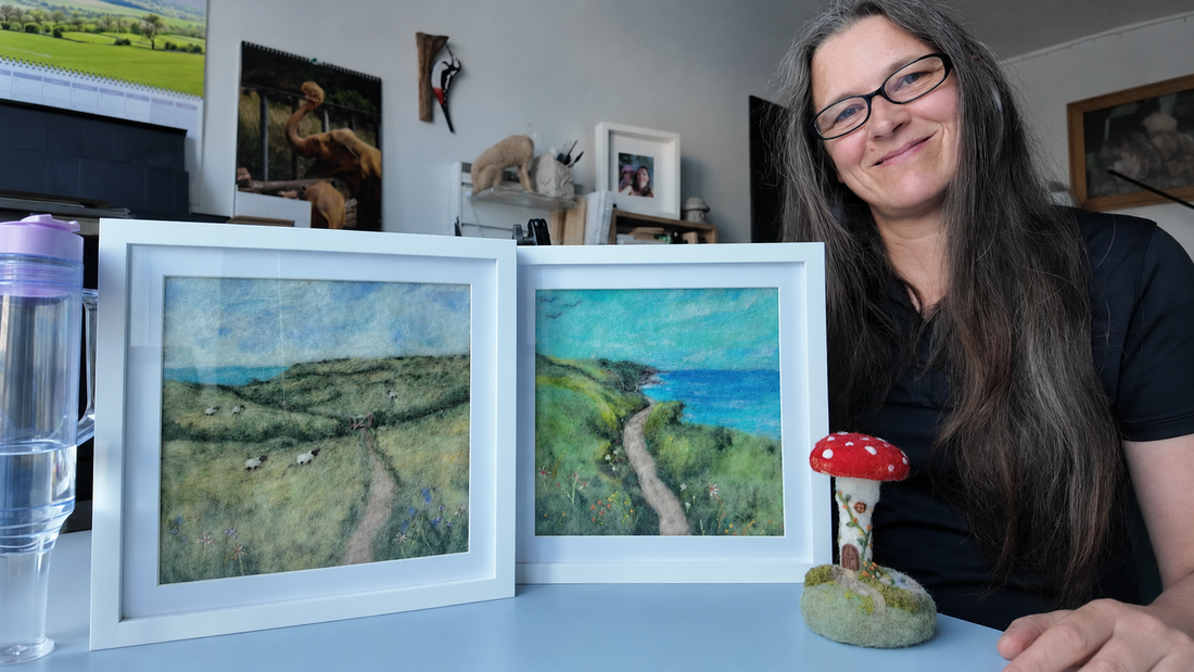 Justine with two framed needle-felted Devon landscapes and the Garden at Toadstool House