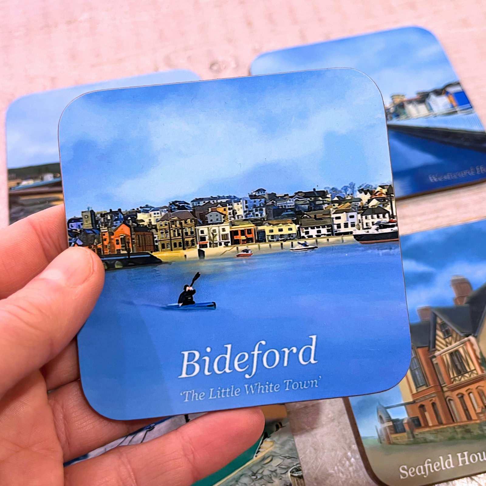 Bideford Town coaster with blue sky and kayaker, held in hand, by Jagos Art
