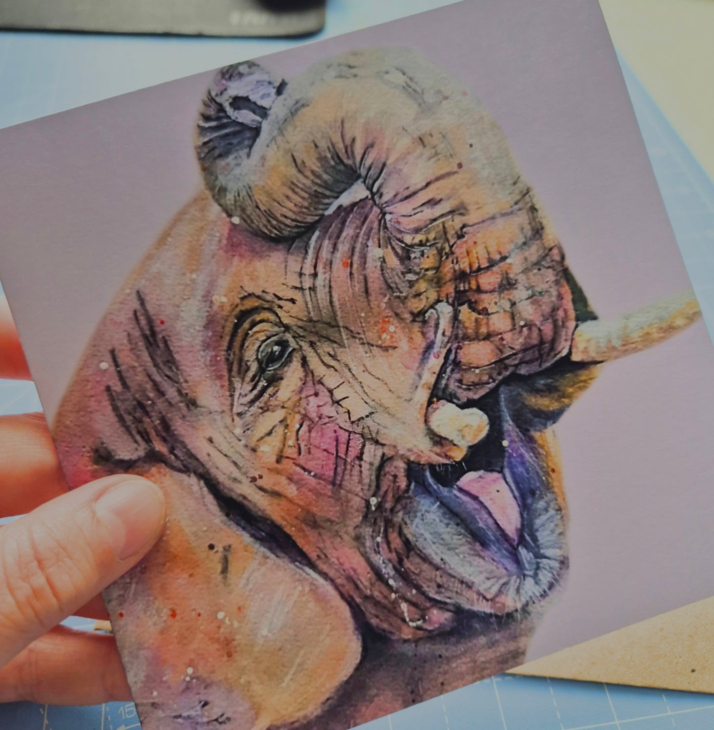 Elephant greeting card being held in the hand