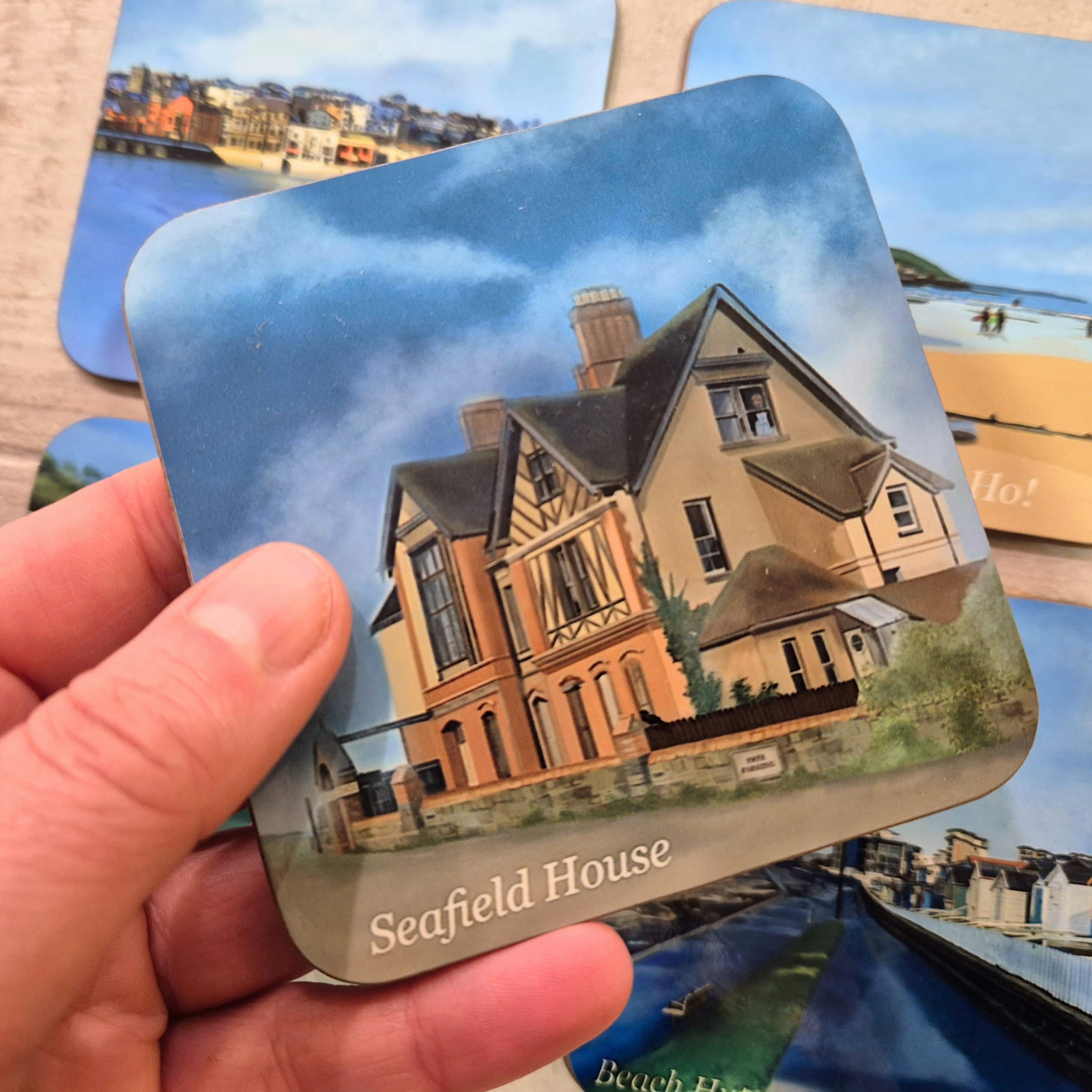 Seafield Haunted house coaster by Jagos Art with house and haunting cloudy skies