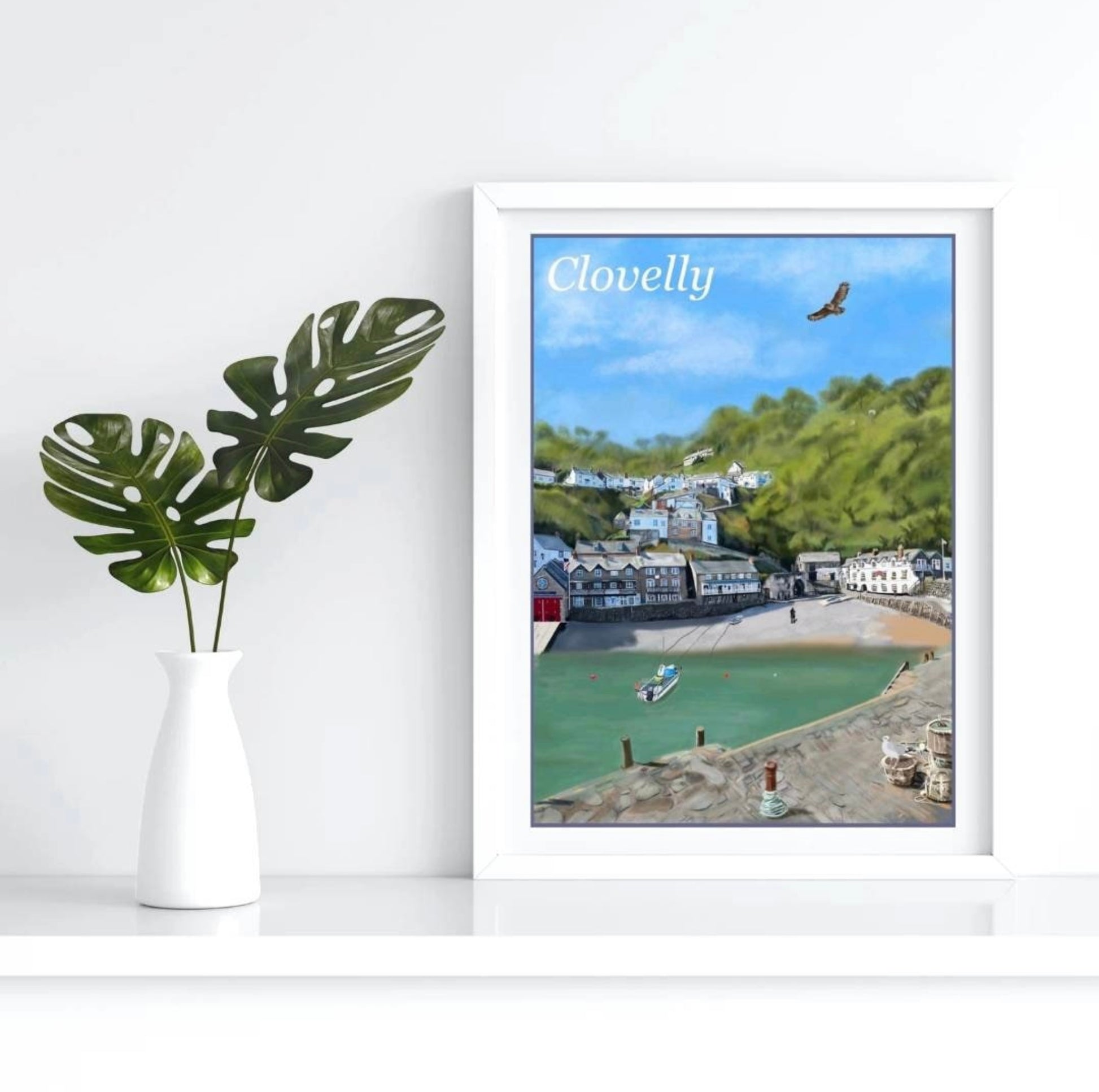 an art print by Jagos Art of Clovelly in North Devon featuring the Harbour, the Red Lion hotel, the lifeboat station amd the quaint cottages running up the hill 