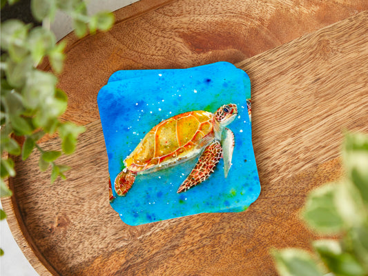 A coaster featuring a print of an original mixed media painting of a stunning Sea Turtle swimming in the beautiful vibrant blue sea