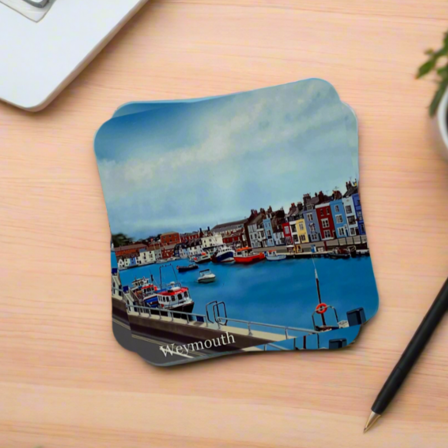 Weymouth Harbour coaster in Dorset with boats, harbour shops, blue water and blue sky on a desk