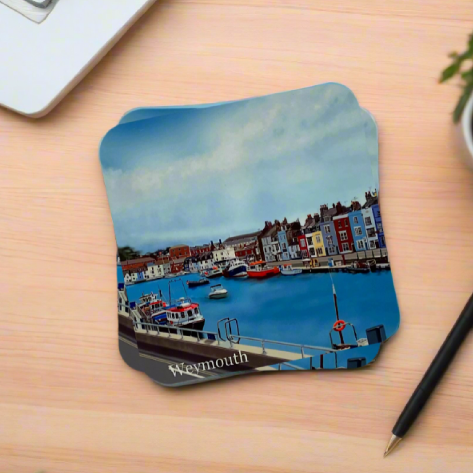 Weymouth Harbour coaster in Dorset with boats, harbour shops, blue water and blue sky on a desk