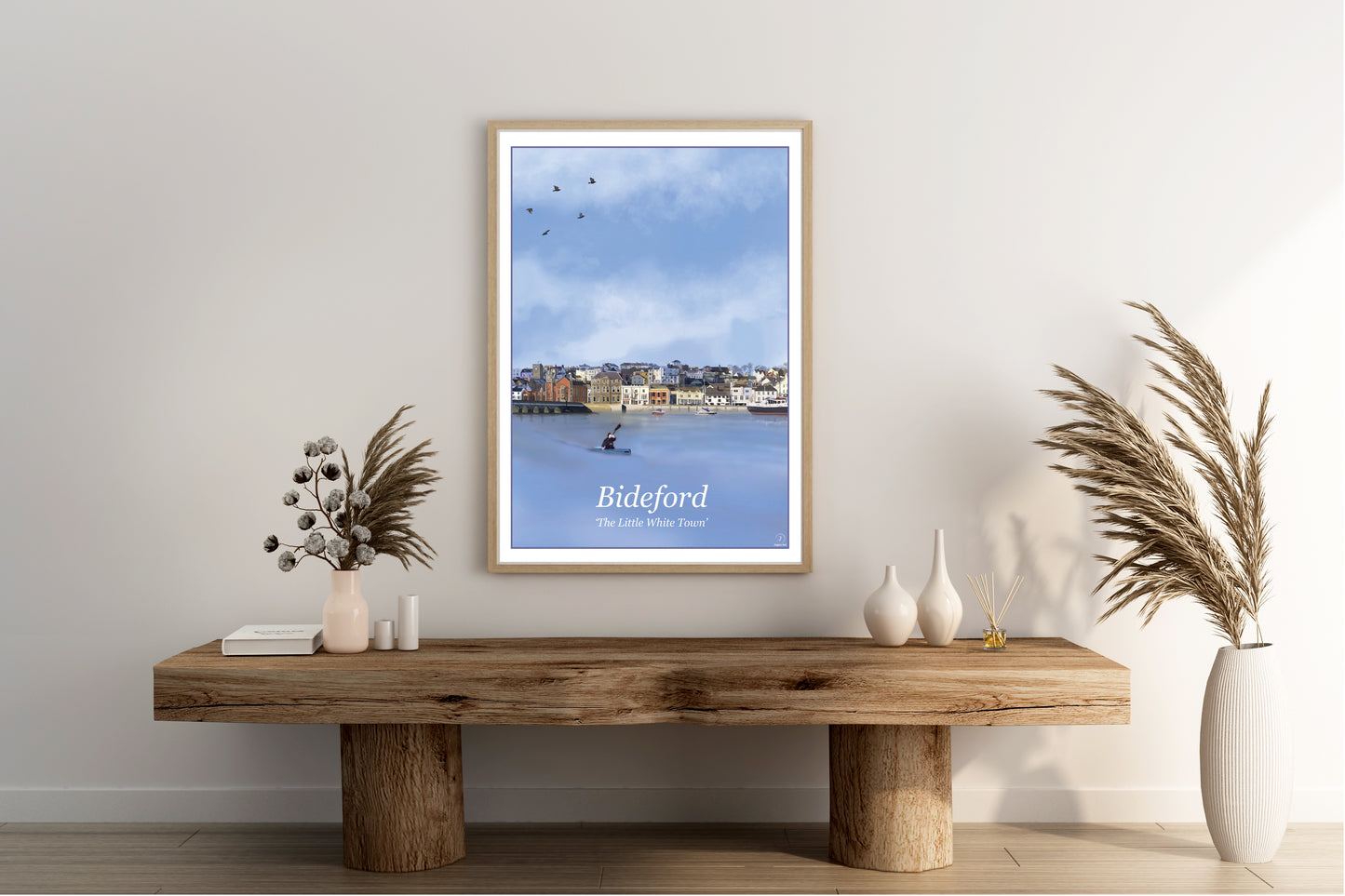 An Art Print by Jagos Art featuring the town of Bideford in North Devon Engalnd showing the old bridge, the river and the town buildings drawn in the style of the old vintage railway posters primarily in the colour blue