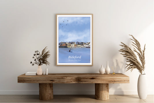 An Art Print by Jagos Art featuring the town of Bideford in North Devon Engalnd showing the old bridge, the river and the town buildings drawn in the style of the old vintage railway posters primarily in the colour blue