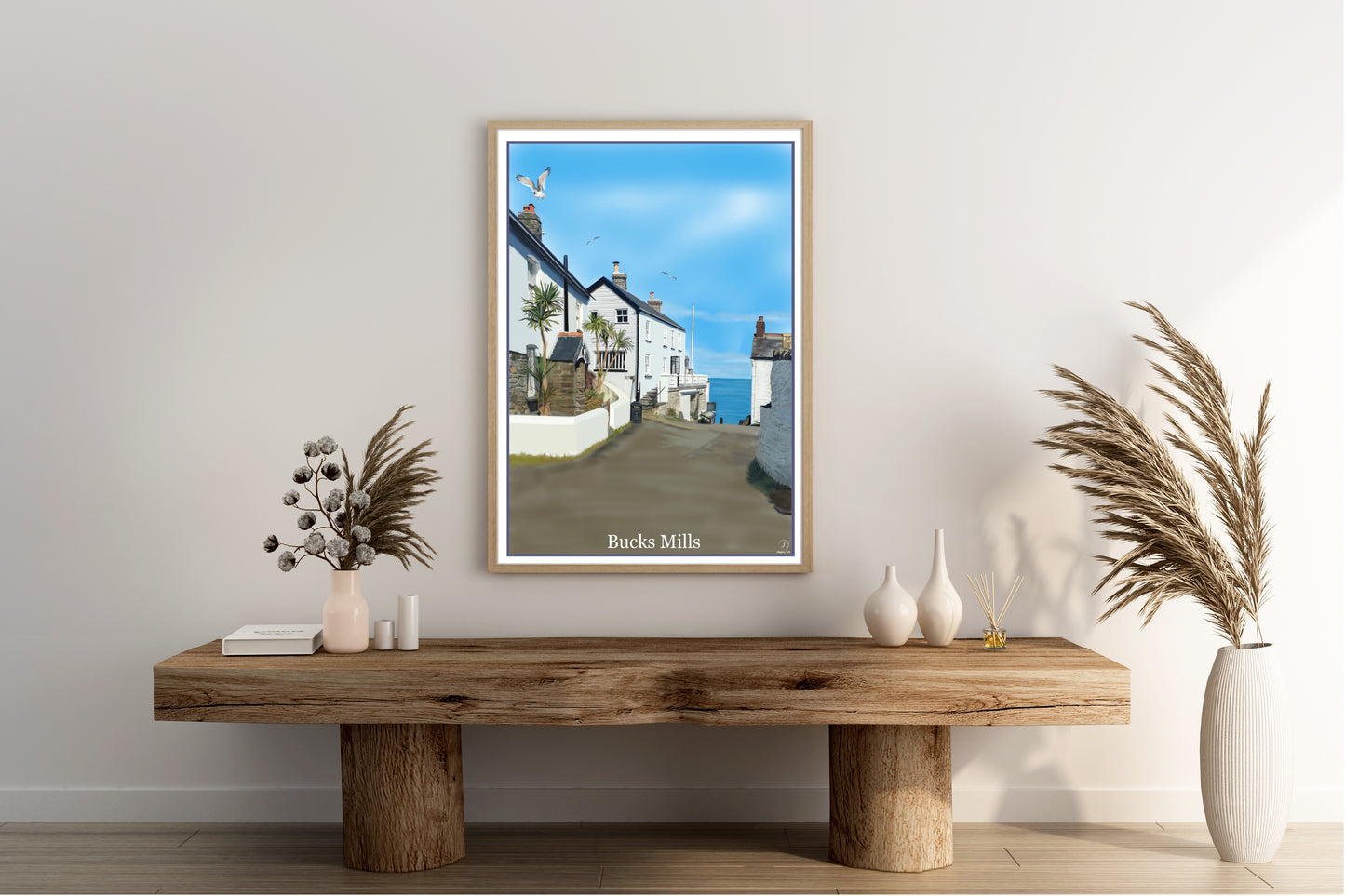 An art print by Jagos Art featuring the gorgeous hidden away village of Bucks Mills in North Devon England showing some of the houses, the sea and seagulls flying overhead drawn in the style of the old vintage railway posters