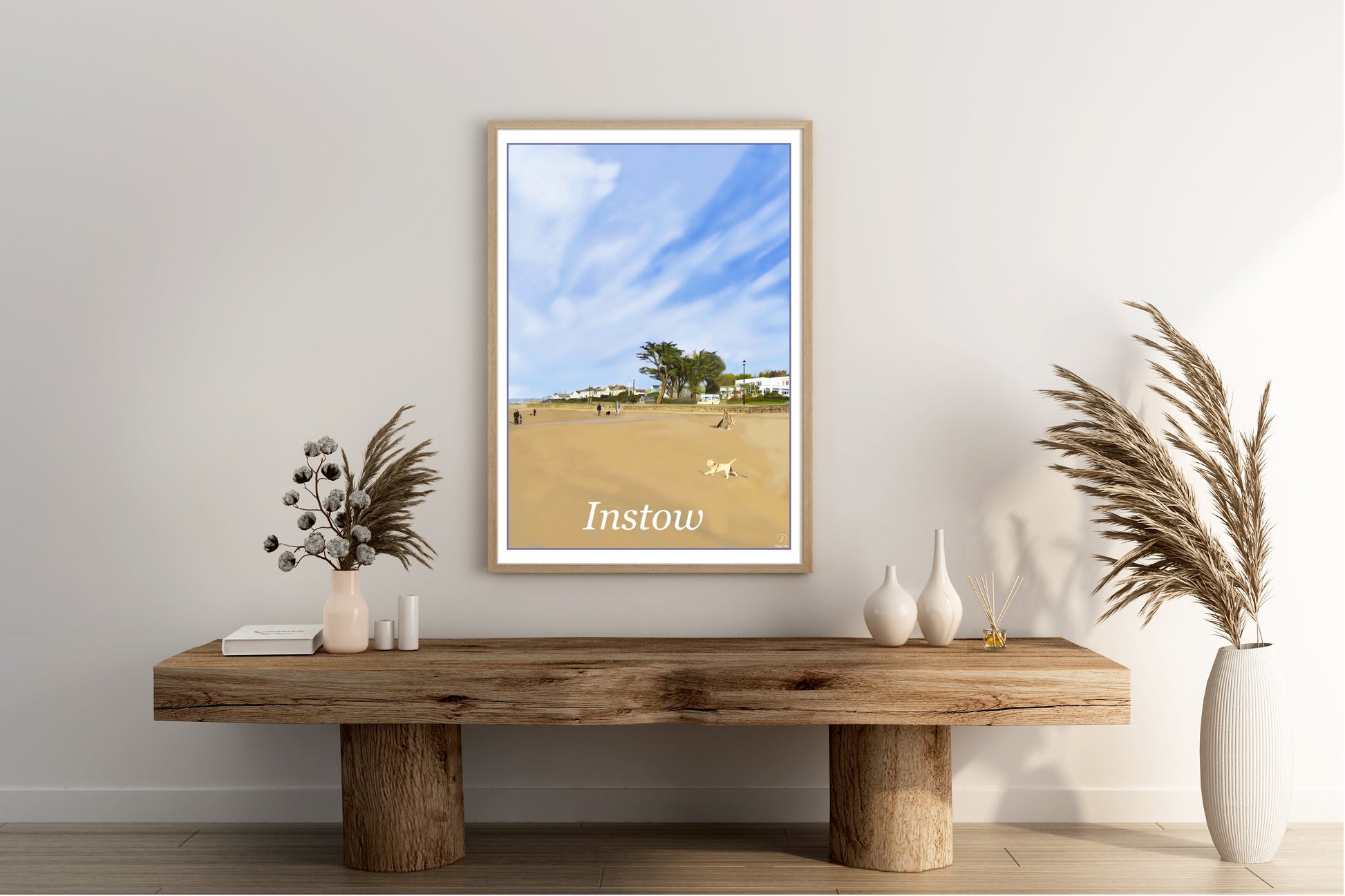 An art print of Instow beach in North Devon England featuring the commordore hotel in the background, the large trees and the sandy beach with a small dog running painted in the style of the old vintage railway posters with primary colours blue, sandy orange and green