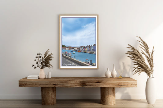 An art print of Weymouth Harbour in Dorset England featuring the harbour with the boats moored up and the beautifully painted buildings painted in the style of the old vintage railway posters